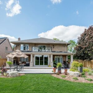 a large house with a patio and umbrellas