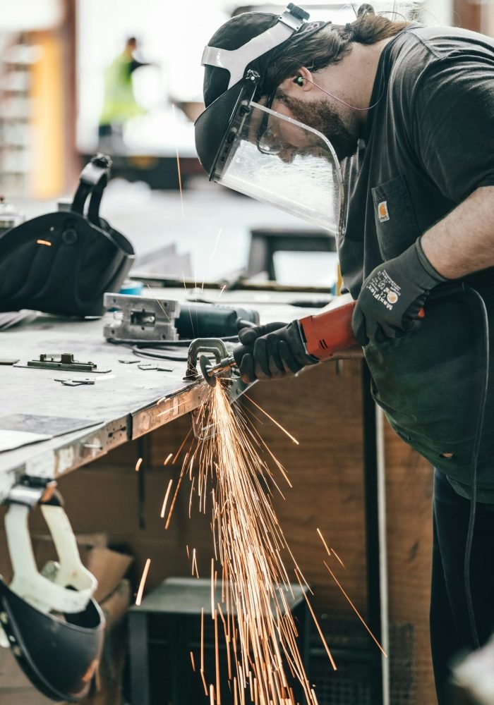 Photo by Spencer Davis man using angle grinder